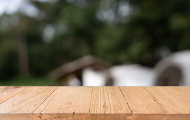 Empty wood table top and blur of restaurant background selective focus product display