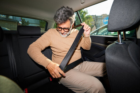 Man fastens seatbelt