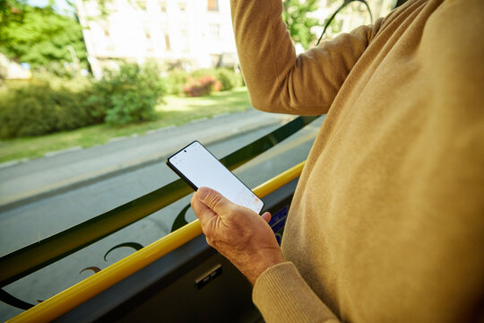Man uses mobile phone in the bus