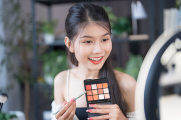 beauty blogger Young Asian girl makeup artist Professional Woman blogger vlogger is showing...