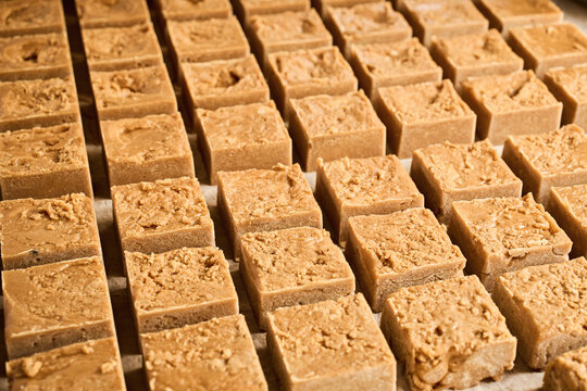 Sugar cane cubes drying under sunlight, ready to be packed