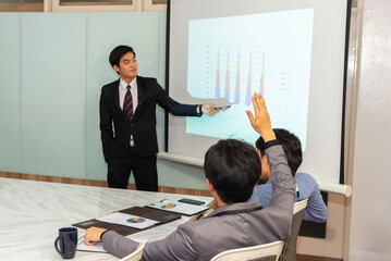 Motivated professional team members gathered together at corporate seminar raise hand, agree with...