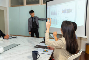 Motivated professional team members gathered together at corporate seminar raise hand, agree with...
