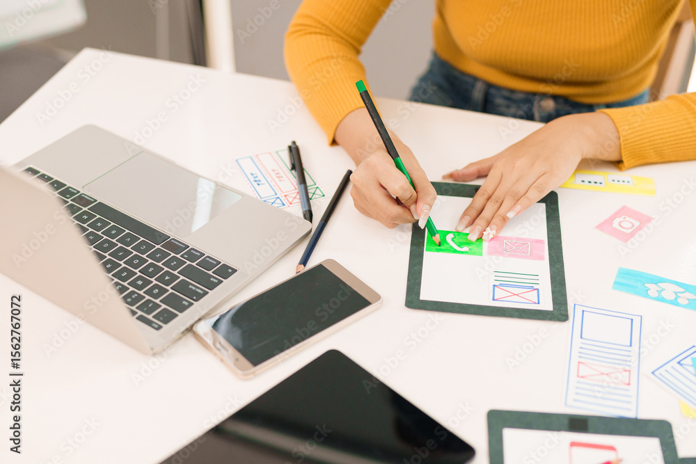 Canvas Prints user interface designer asian woman creating mobile app design on tablet with laptop and devices for
