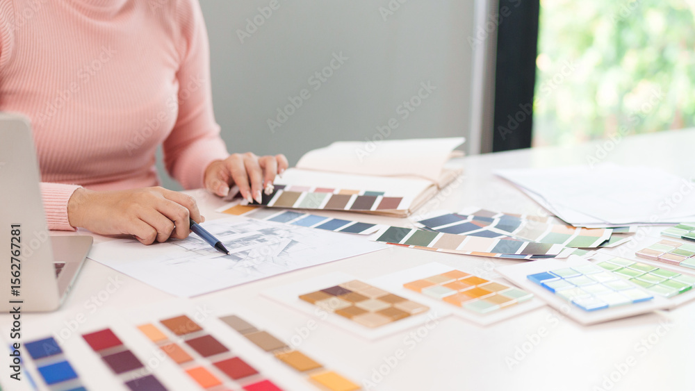 Wall mural asian woman ui designer color palette choosing at desk with laptop for website design, web app devel