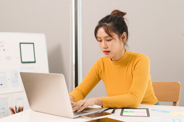 Asian Adult Woman UI UX Designer Working on Laptop Designing Mobile App Interface Website Mockup...