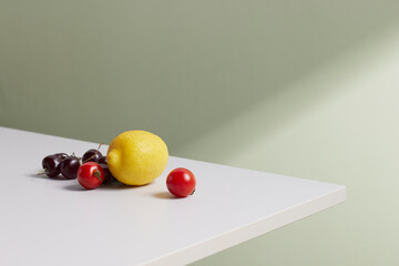 A cozy backdrop with fresh fruits and grass on a table with natural sunlight and shadows.
