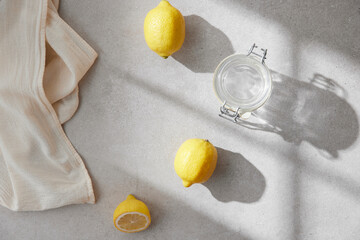 A cozy backdrop with fresh fruits and grass on a table with natural sunlight and shadows.