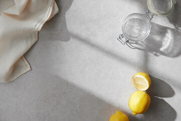 A cozy backdrop with fresh fruits and grass on a table with natural sunlight and shadows.
