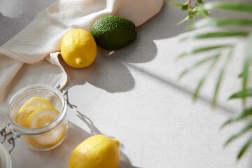 A cozy backdrop with fresh fruits and grass on a table with natural sunlight and shadows.