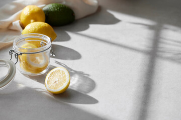 A cozy backdrop with fresh fruits and grass on a table with natural sunlight and shadows.