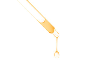 gold serum oil dripping from dropper isolated on white background