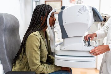 Doctor using medical technology for eye exam in clinic
