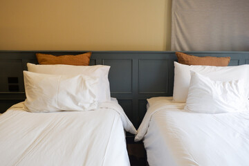 Hotel room scene with bed pillows and lamp on table,White soft pillows on bed,contemporary,Space for text.