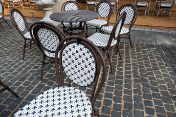 Classic white steel chair and table in the garden,empty white vintage chairs in the garden,decoration english garden concept.