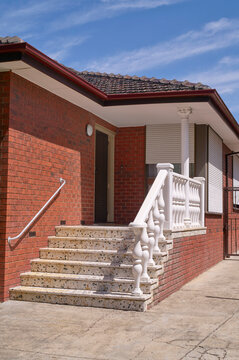 Sturdy brick steps lead to a 'Italianized' Melbourne brick home