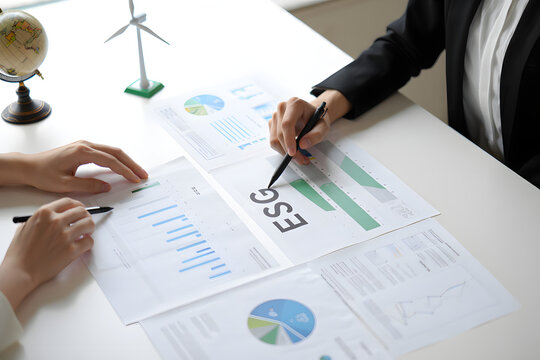 ESG Investment Strategy Meeting: Businesswomen Analyze Charts and Graphs, Sustainable Growth Planning.