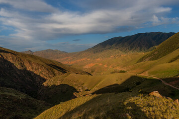 Picturesque mountain landscape with red soil in Almaty region in southeastern Kazakhstan on a...