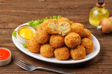 Bitterballen is the name of a type of food in the Netherlands. Bitterballen taste similar to...