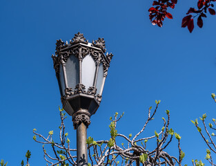 Antique lantern on a pole against the sky in close-up.
