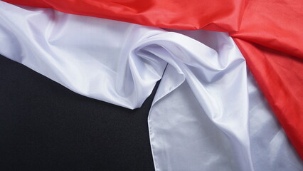 Crumpled red and white Indonesian flag isolated on black background