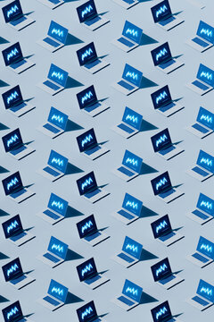  Grid of Laptops Displaying Glowing Analytics Charts