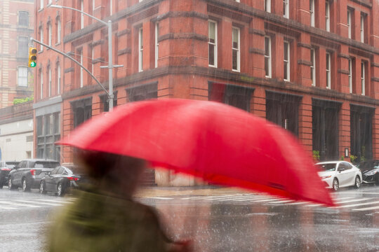 Person with umbrella in heavy rain