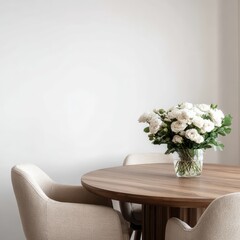 Minimalist dining setting with a round wooden table, two beige upholstered chairs, and a glass vase of white roses against a white wall