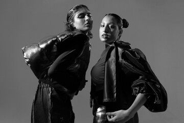 Fashion editorial with two women in bold outfits, black and white pic