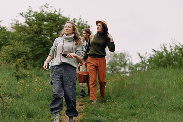 Active middle age women enjoying outdoor fitness walk in nature, focusing on health, wellbeing, and community connection during a beautiful spring day.