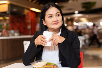 Portrait of a woman in cafe holding coffee cup