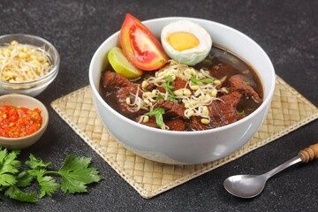 Rawon is a typical Indonesian dish originating from Ponorogo, East Java, which is a black meat soup with a mixture of special spices using kluwek.