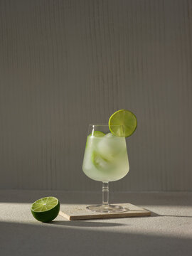 A chilled lime cocktail garnished with a lime slice