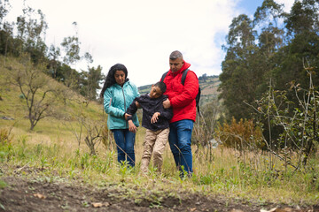 Family supporting child during nature walk