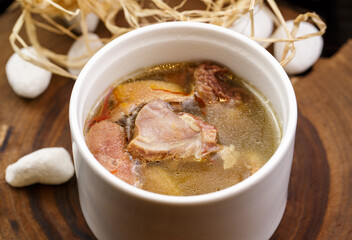 Cordyceps flower and duck soup in white porcelain soup can