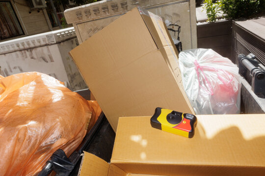 disposable film camera in a trash container