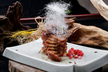 A celadon plate of shredded sugar and honey with yellow rice lotus root is placed on a camphorwood...