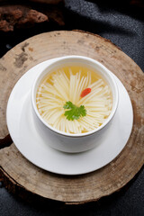Chrysanthemum tofu soup in white porcelain soup bowl