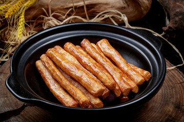 Pan-baked iron stick long yam placed on camphorwood chopping board