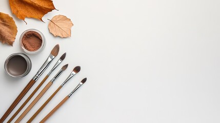 Artistic Display of Paint Brushes, Leaves, and Natural Colors
