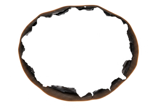 A circular burnt paper with a charred hole and textured edge isolated on transparent background