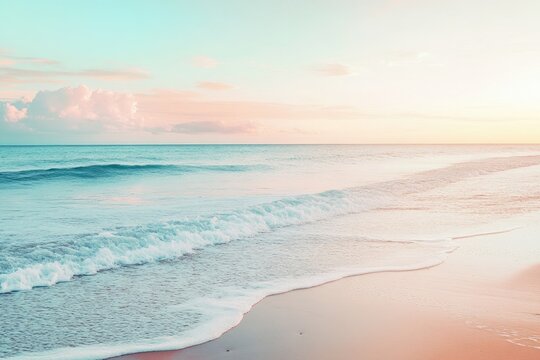 Pastel sunset over a tranquil beach. Gentle waves wash ashore a soft, sandy beach at sunrise or sunset, with pale pink and teal colors blending harmoniously in the sky