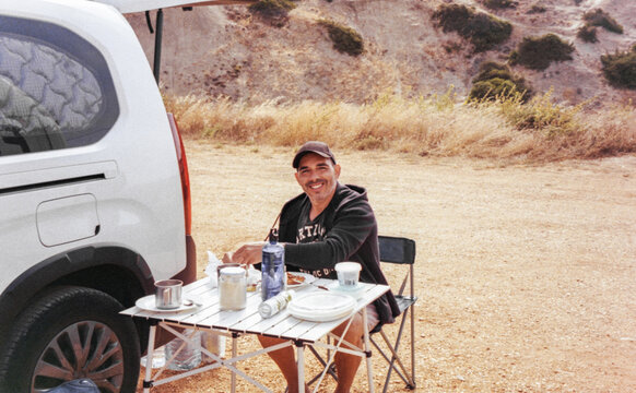 Man Camping by Van Near Sagres Beach
