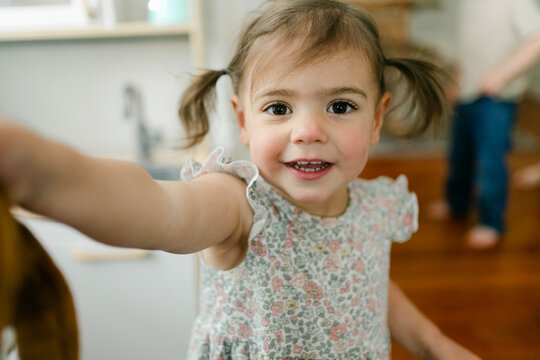 portrait of smiling little girl with pigtails 