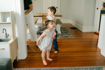 kids  dancing together in living room 