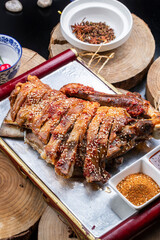 Roasted lamb legs from the grasslands outside the Great Wall are placed on a camphorwood chopping board