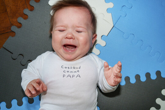 Crying Baby Crying on a Play Mat at Home