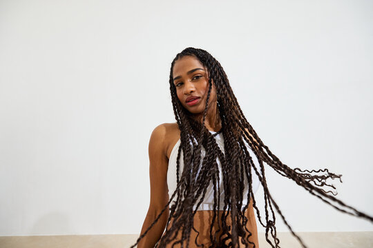 Portrait of a woman with long braided hair in a bright setting