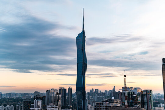 Futuristic skyscraper in cityscape at twilight