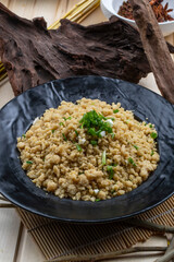 Bashang gourmet fried puppet on a black porcelain plate